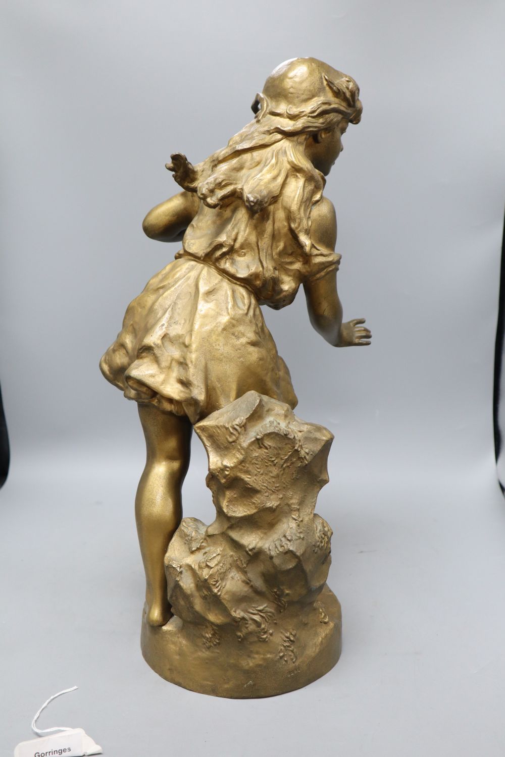 An early 20th century gold painted bronze model of a girl, height 50cm